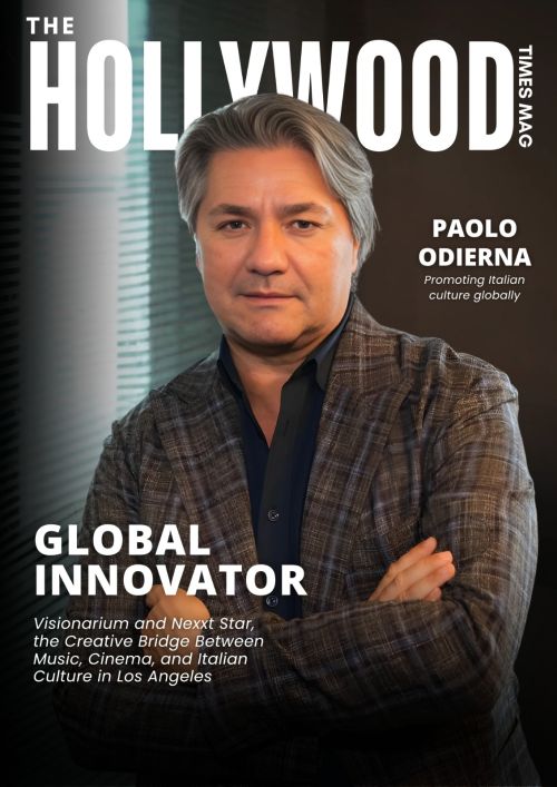 L'immagine mostra la copertina di una rivista intitolata "The Hollywood Times Mag". Al centro della copertina c'è un ritratto di Paolo Odierna, che appare in un primo piano con le braccia incrociate. Indossa una giacca a quadri e una camicia scura, con un'espressione sicura e professionale. Lo sfondo è sfumato e moderno, con elementi architettonici e illuminazione soffusa.  Il testo sulla copertina lo definisce un "Global Innovator" e menziona il suo ruolo nella promozione della cultura italiana a livello internazionale. Viene citato Visionarium e Nexxt Star, descritti come un ponte creativo tra musica, cinema e cultura italiana a Los Angeles.  L'immagine trasmette un senso di prestigio e innovazione, evidenziando il contributo di Odierna nel mondo dell'intrattenimento e della cultura.